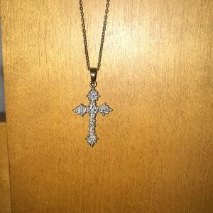 Gold diamond studded cross necklace.